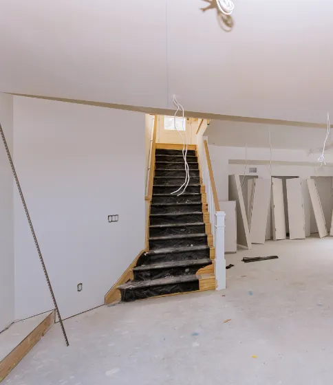 Los Angeles home remodeling project in progress with interior stairs, unfinished flooring, and renovation preparation.