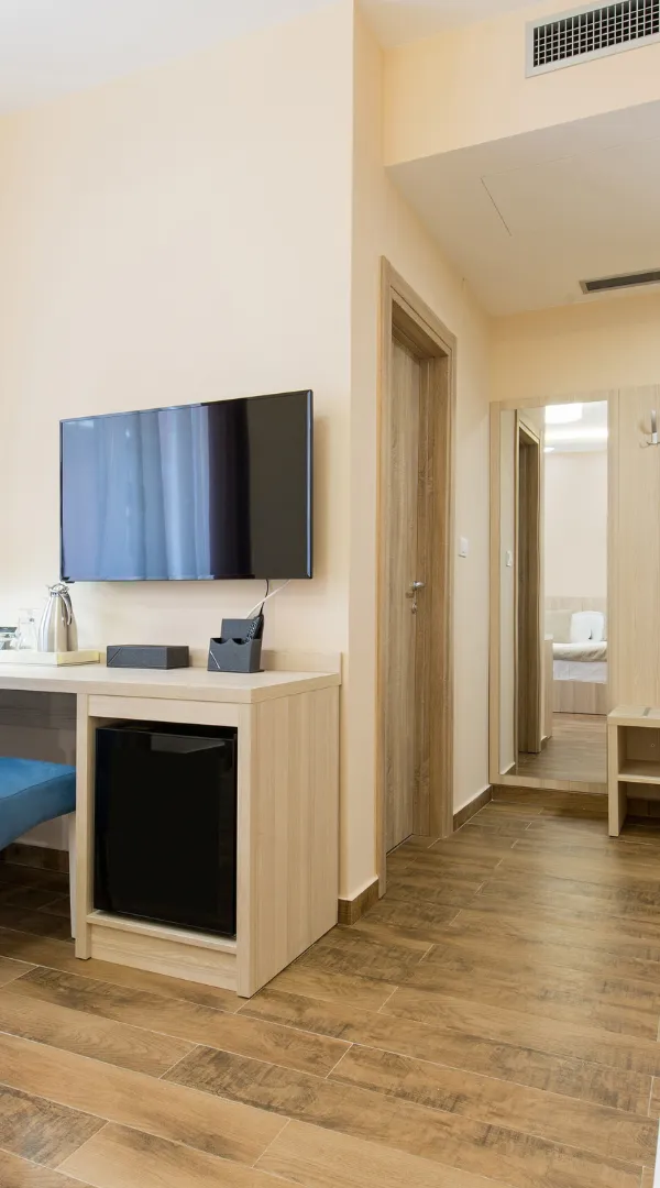 Finished Los Angeles interior remodeling space with updated flooring, modern doors, wall-mounted TV, and clean room design.