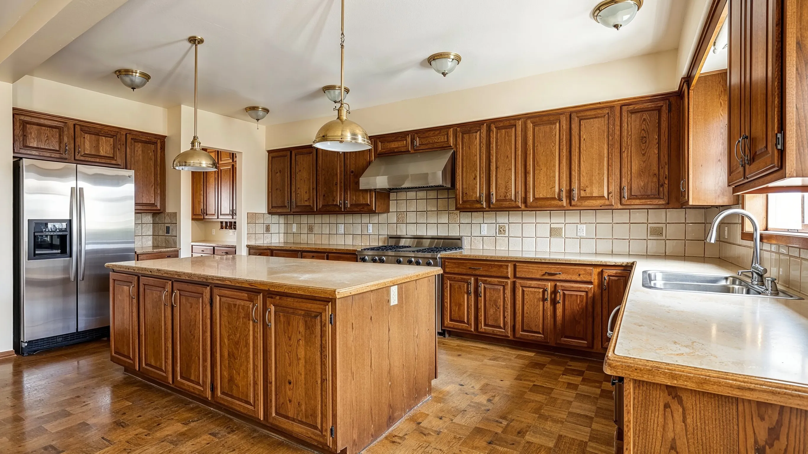 Before kitchen remodeling project in Los Angeles showing outdated wood cabinets, older countertops, traditional lighting, and a layout ready for renovation.