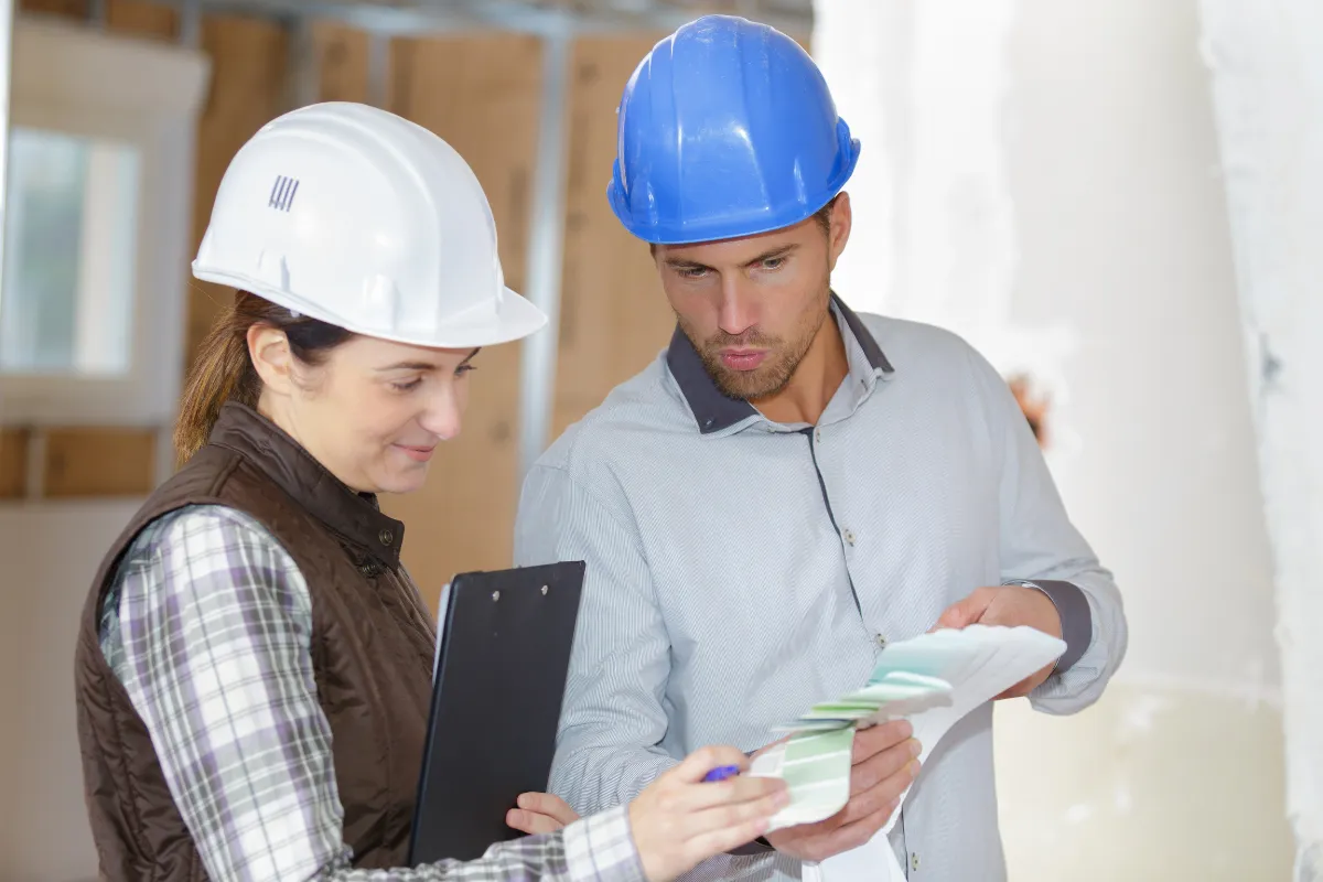 Remodeling permits and planning consultation in Los Angeles with contractors reviewing design materials and project details